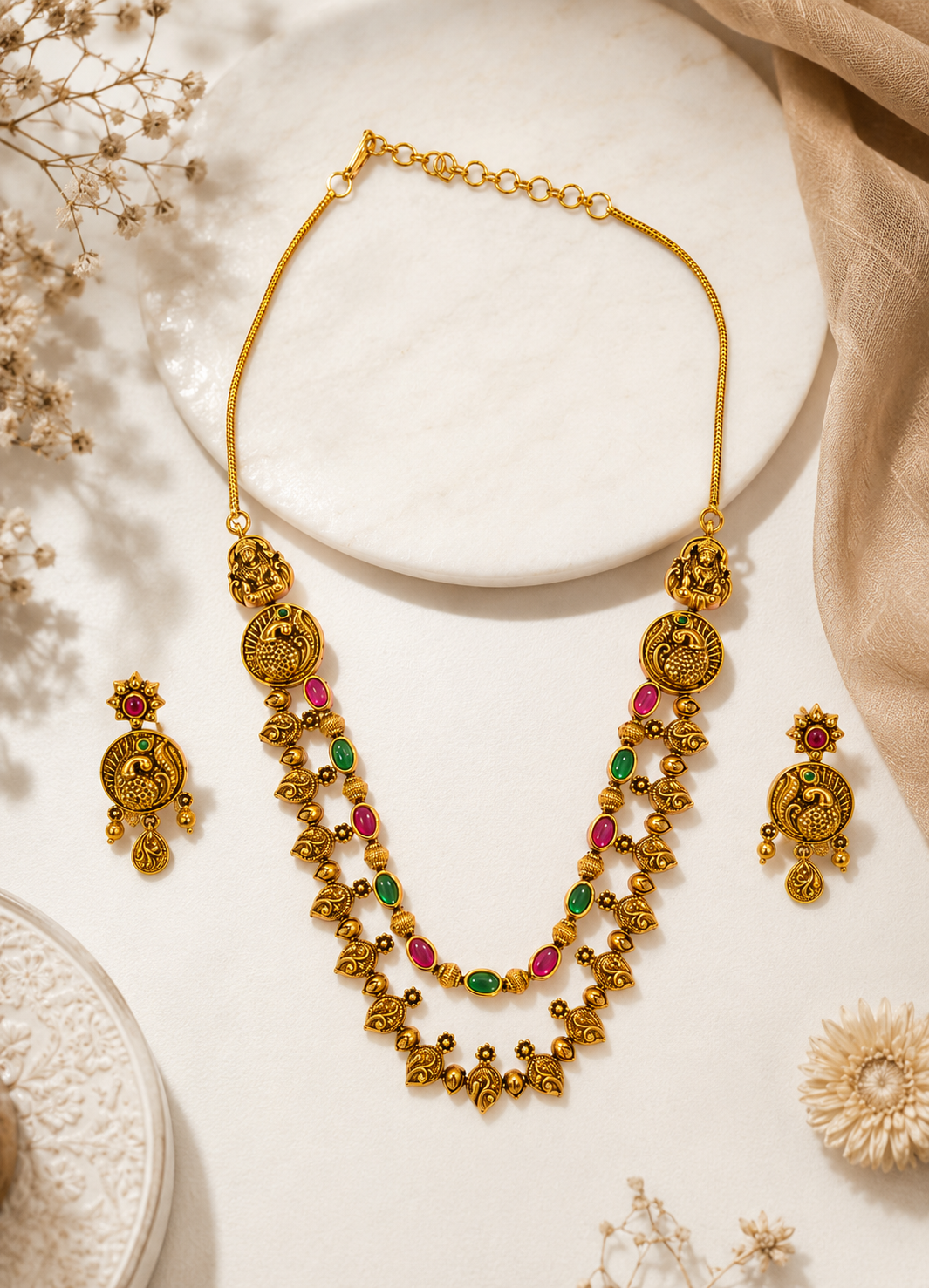 Close-up of ORELVA traditional peacock temple necklace with pink and green stones.