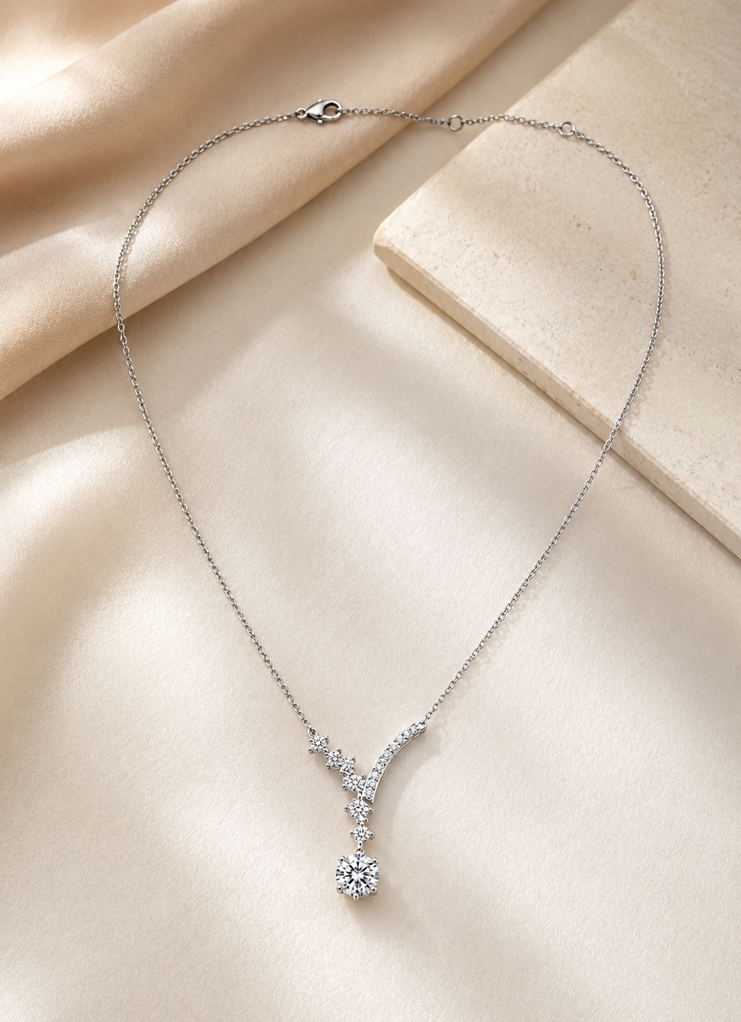 Elegant ORELVA Celeste Cascade sterling silver necklace with sparkling CZ stones on a white background.