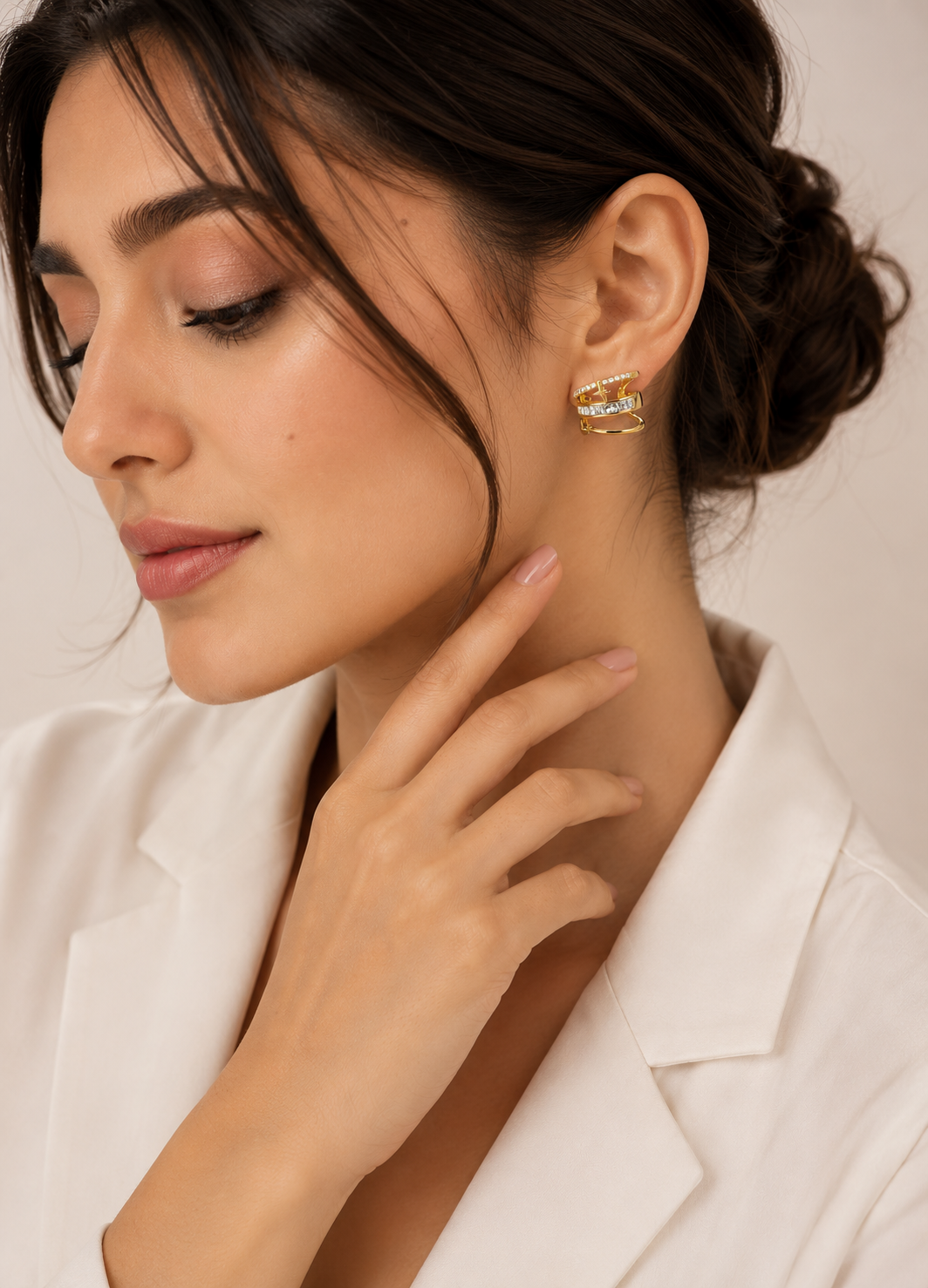 Orelva Celestia Luxe gold-plated triple band CZ ear cuff worn by a female model without piercing