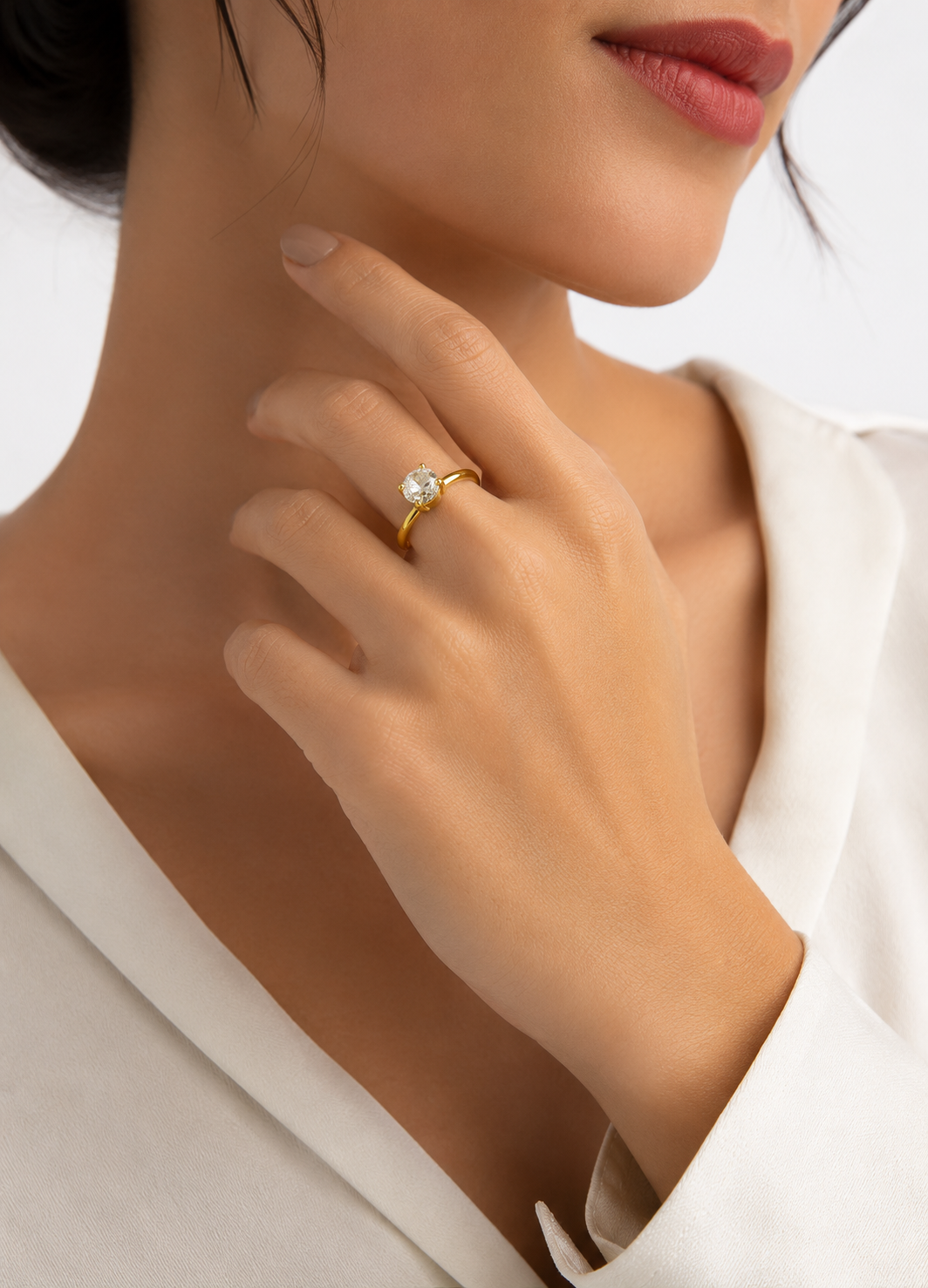 Woman wearing ORELVA Gold-Plated Adjustable Solitaire Ring with brilliant round cubic zirconia stone