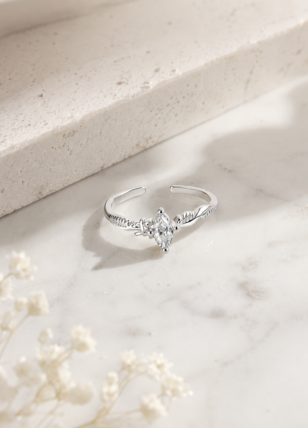 Orelva marquise crystal silver adjustable ring displayed on marble surface