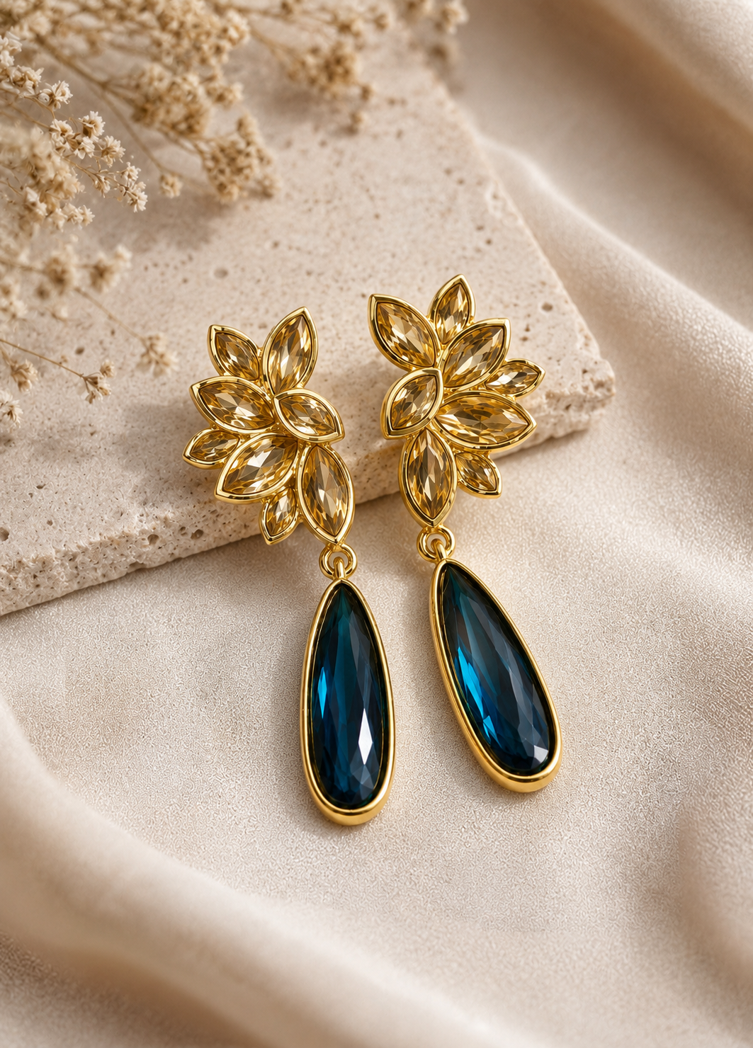 ORELVA Midnight Bloom blue crystal drop earrings displayed on a premium neutral background.