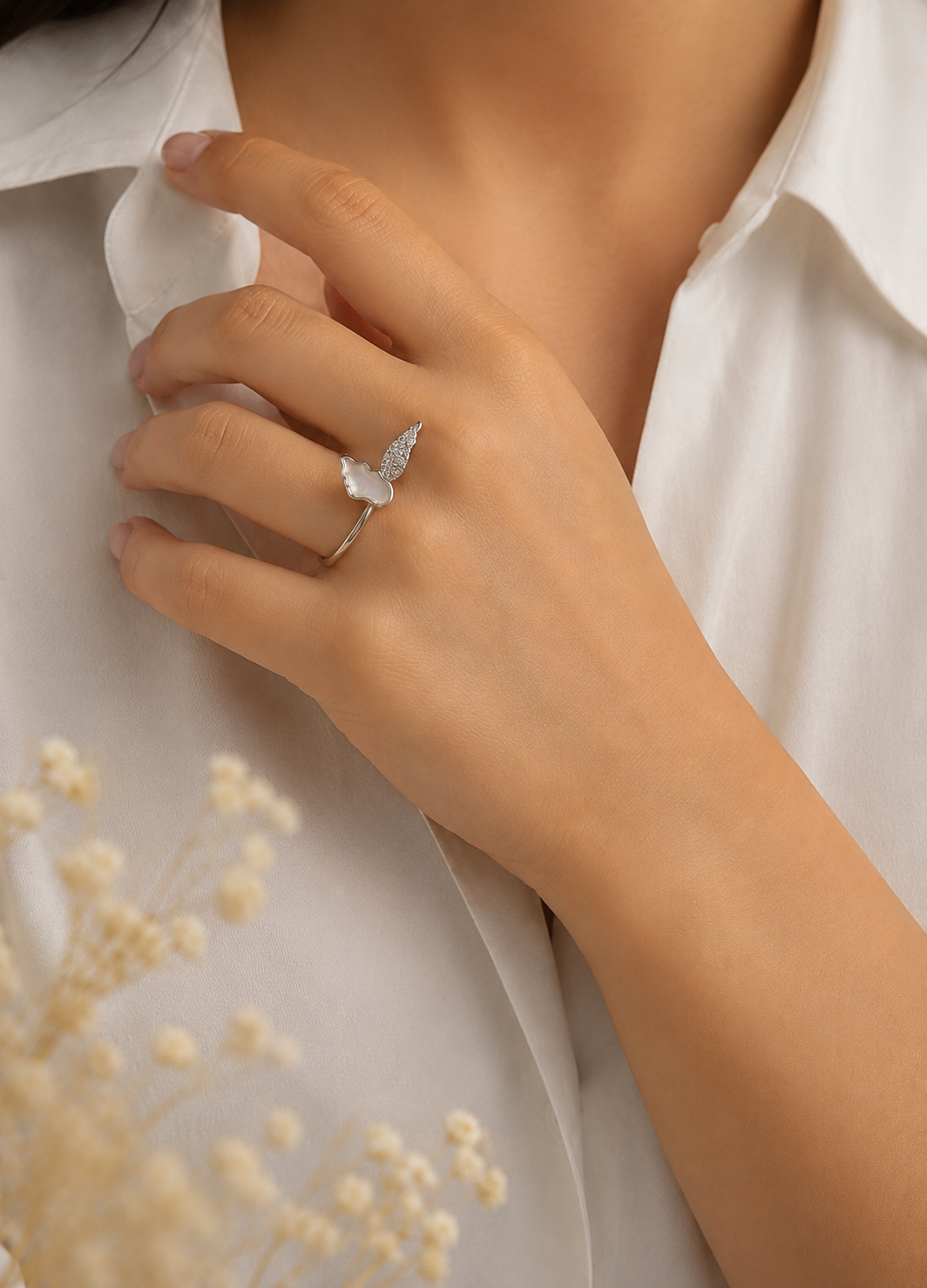 Woman wearing Orelva silver butterfly ring with mother of pearl and crystal detailing