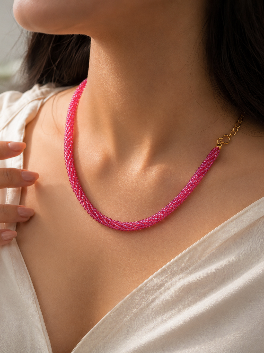 Orelva handcrafted pink beaded choker necklace worn by woman with elegant fashion styling