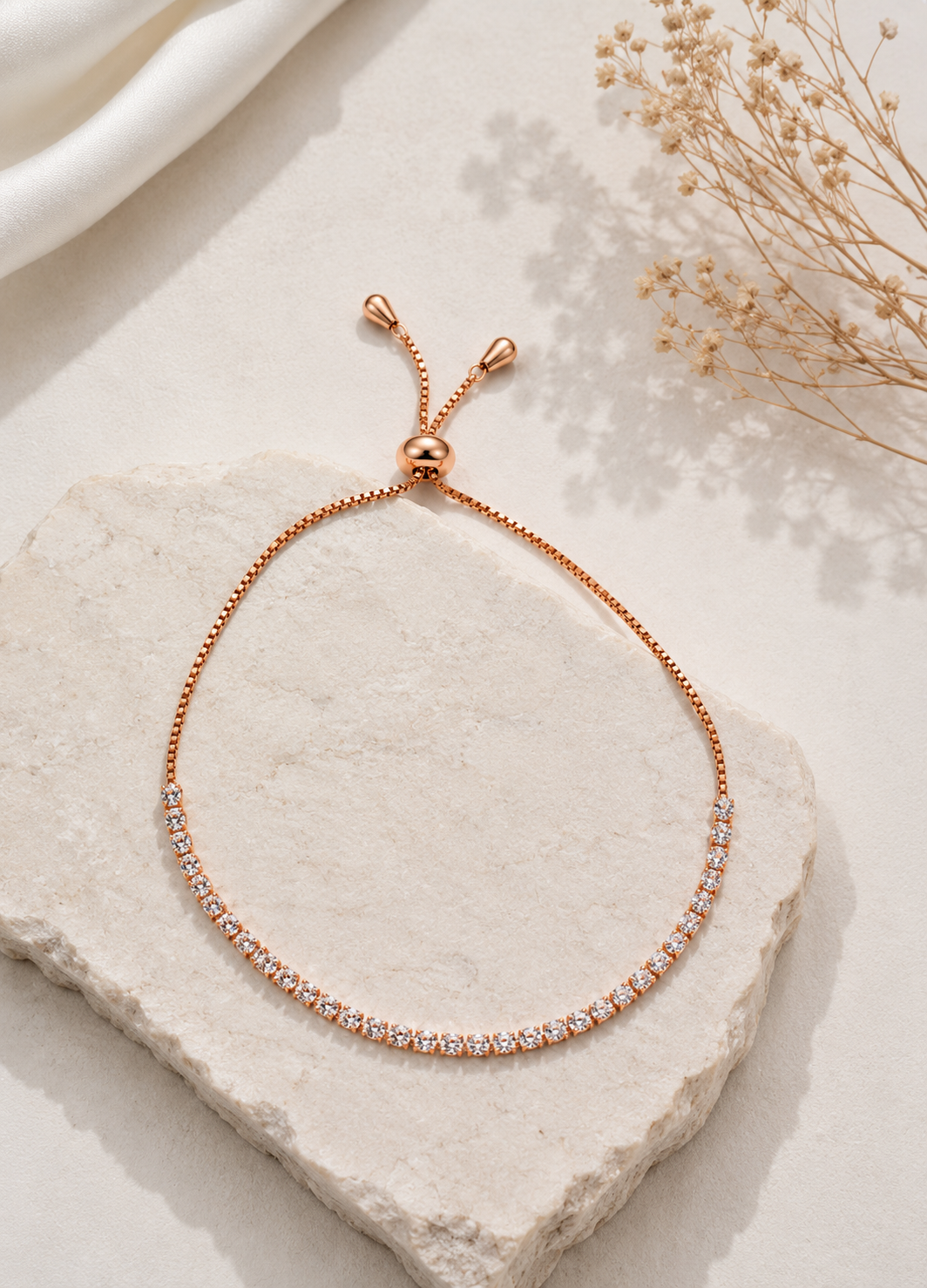Orelva rose gold crystal adjustable bracelet worn elegantly on a woman's wrist