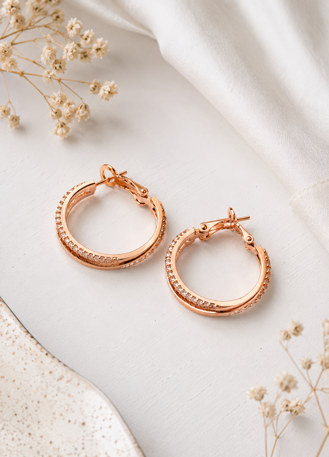 Rose gold plated crystal hoop earrings with premium zircon stones displayed on a minimal white background.