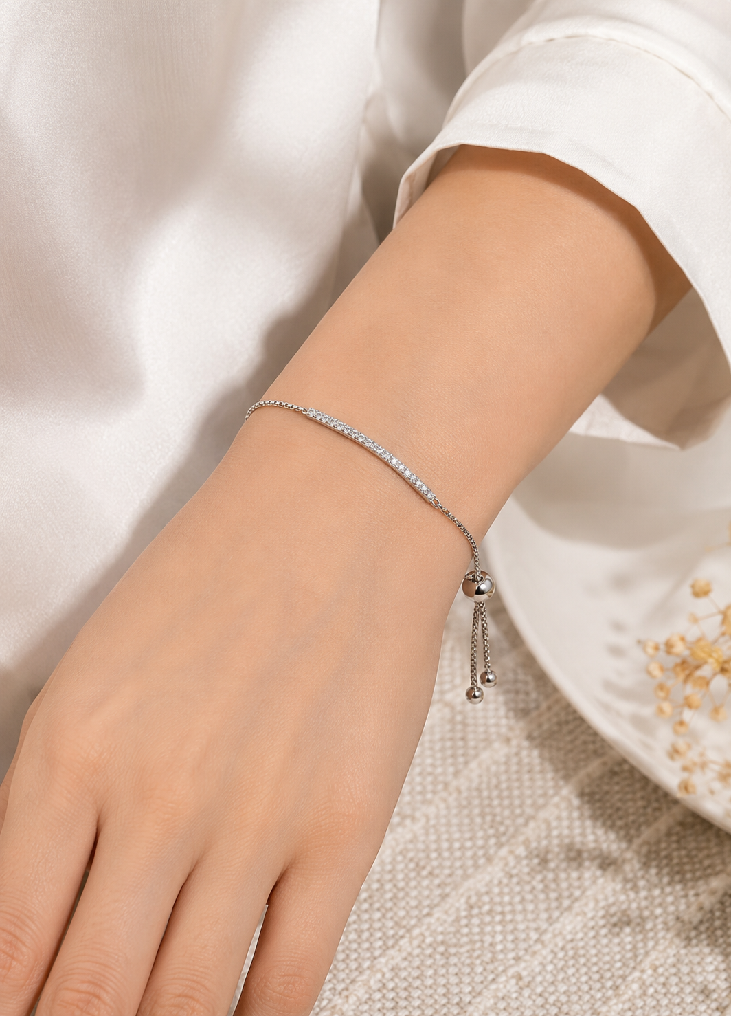 Orelva silver crystal bar adjustable bracelet worn on a woman's wrist