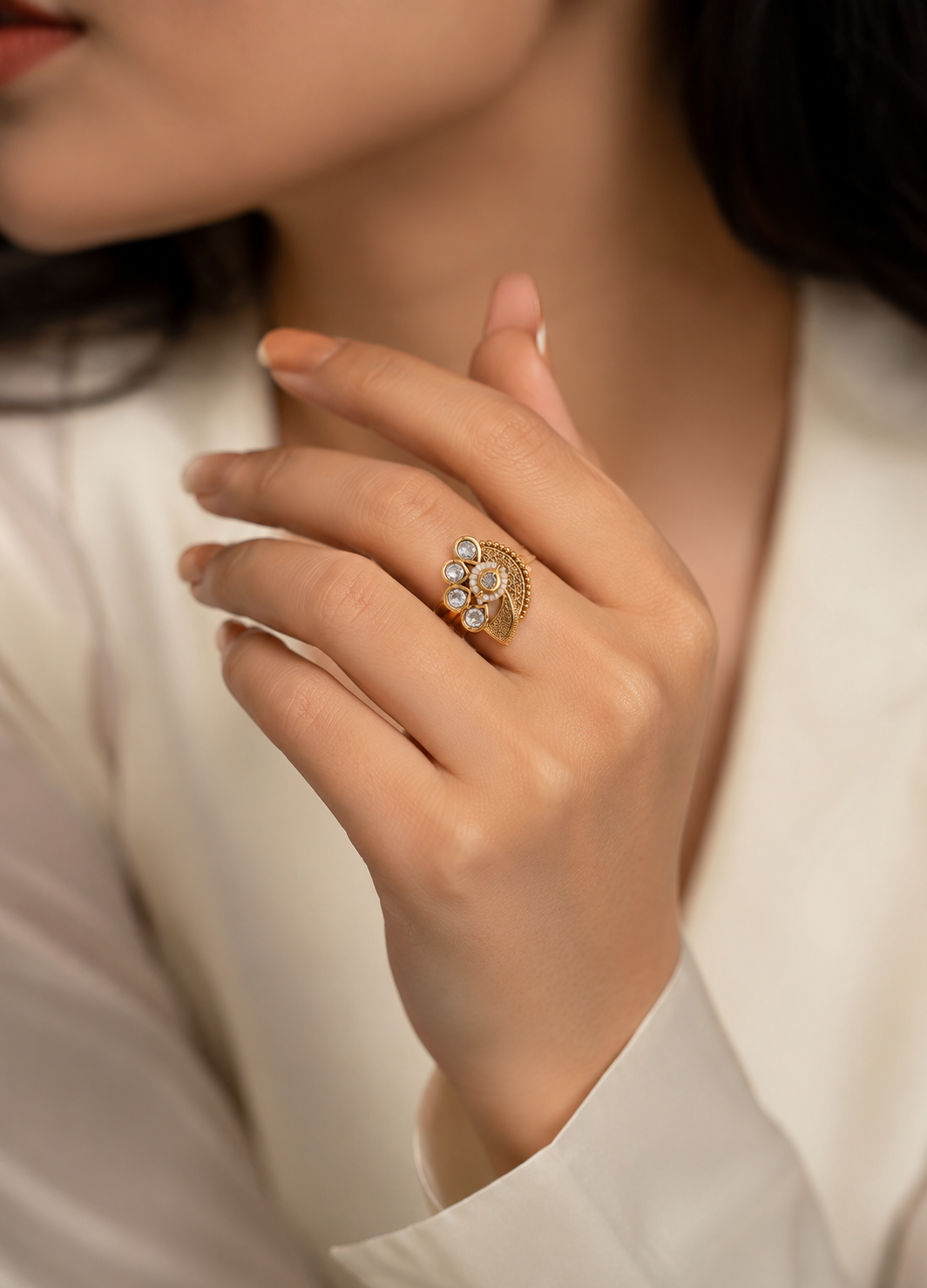 ORELVA Varnika floral gold-plated adjustable Kundan ring worn by a woman, showcasing elegant crystal and pearl detailing.