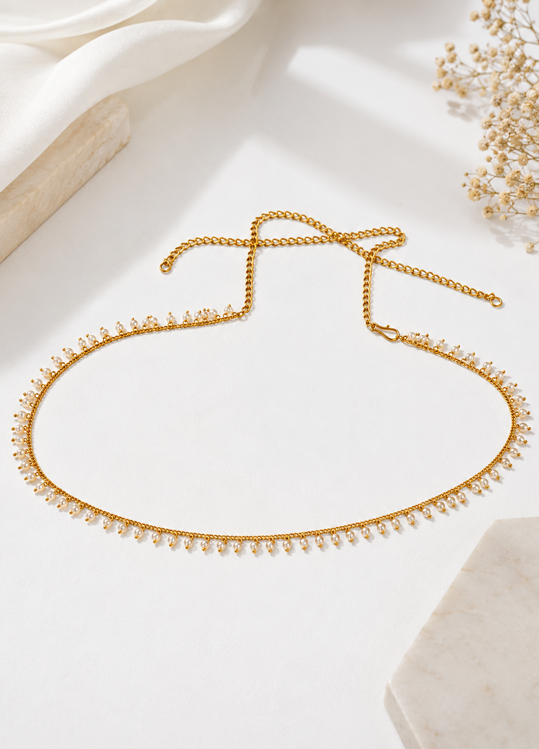 Pearl Drape adjustable gold waist chain with pearl detailing displayed on a premium white background.