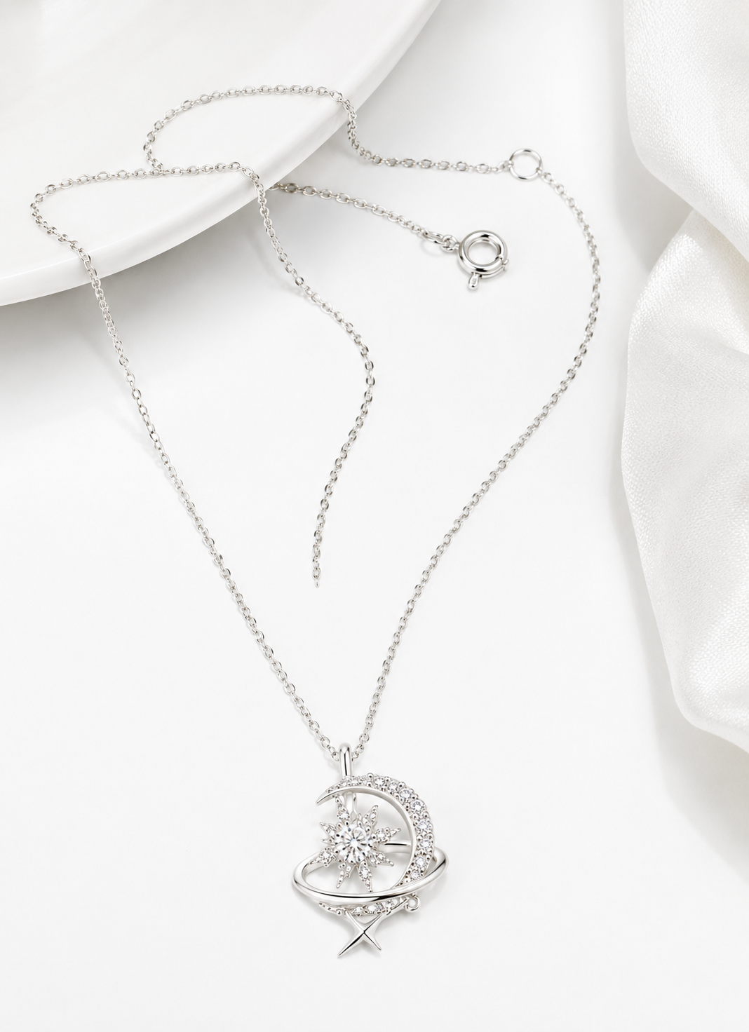 Close-up of a 925 sterling silver moon and star pendant necklace with brilliant cubic zirconia detailing.