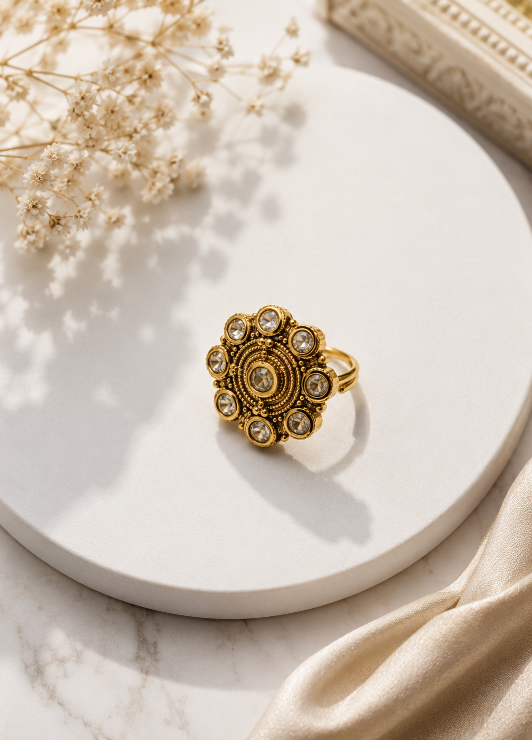 ORELVA Advika antique floral adjustable ring displayed on a premium white marble surface with elegant floral styling.