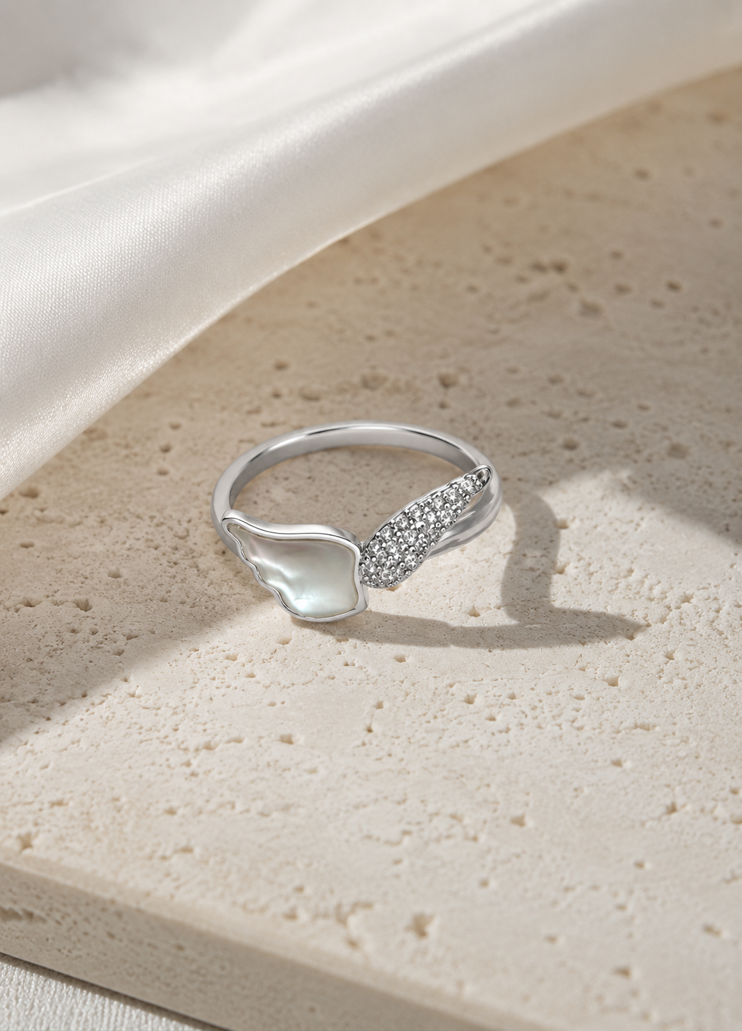 Orelva butterfly-inspired mother of pearl crystal ring on elegant stone surface