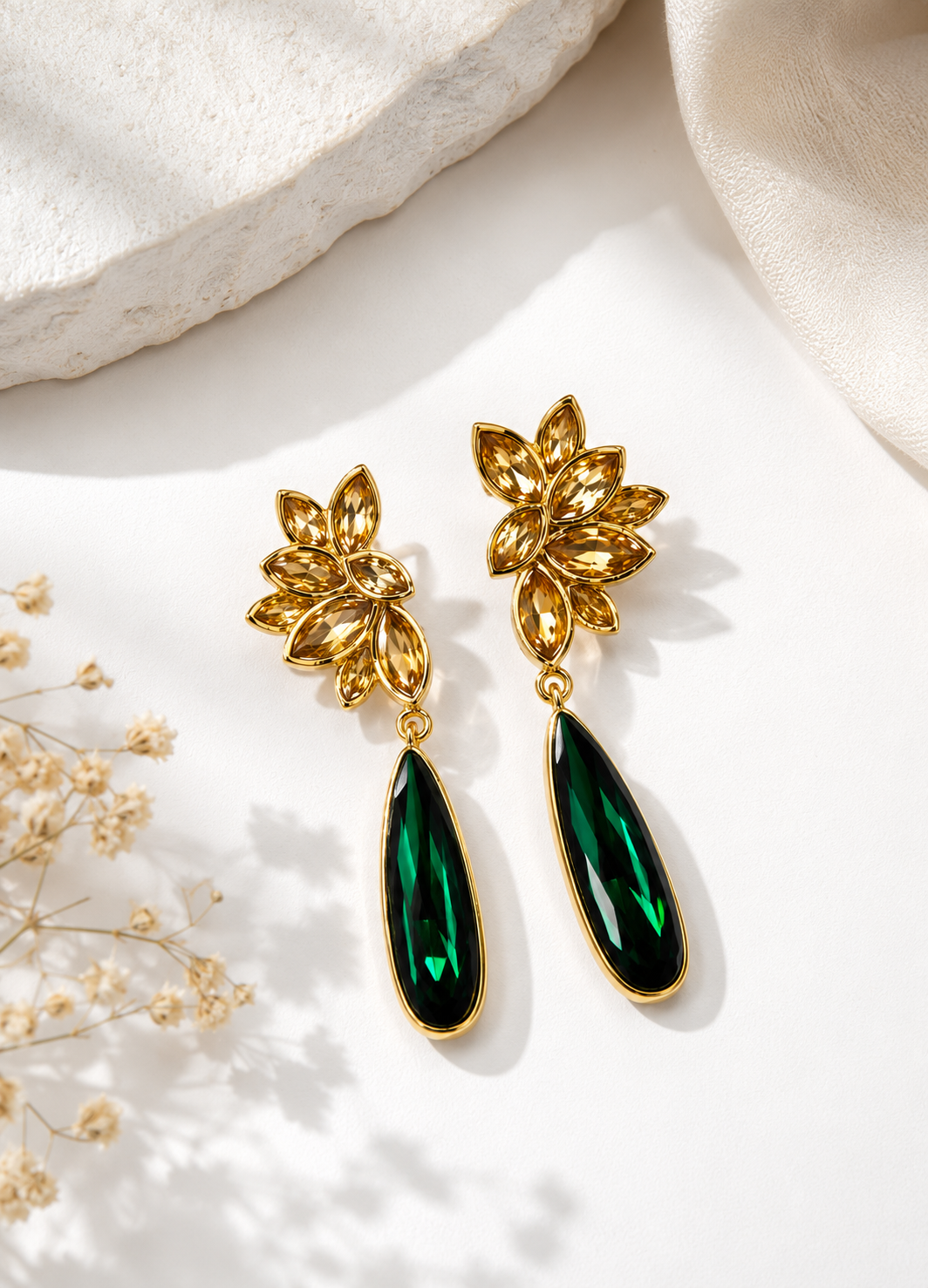Gold-plated emerald green crystal drop earrings with elegant floral design.
