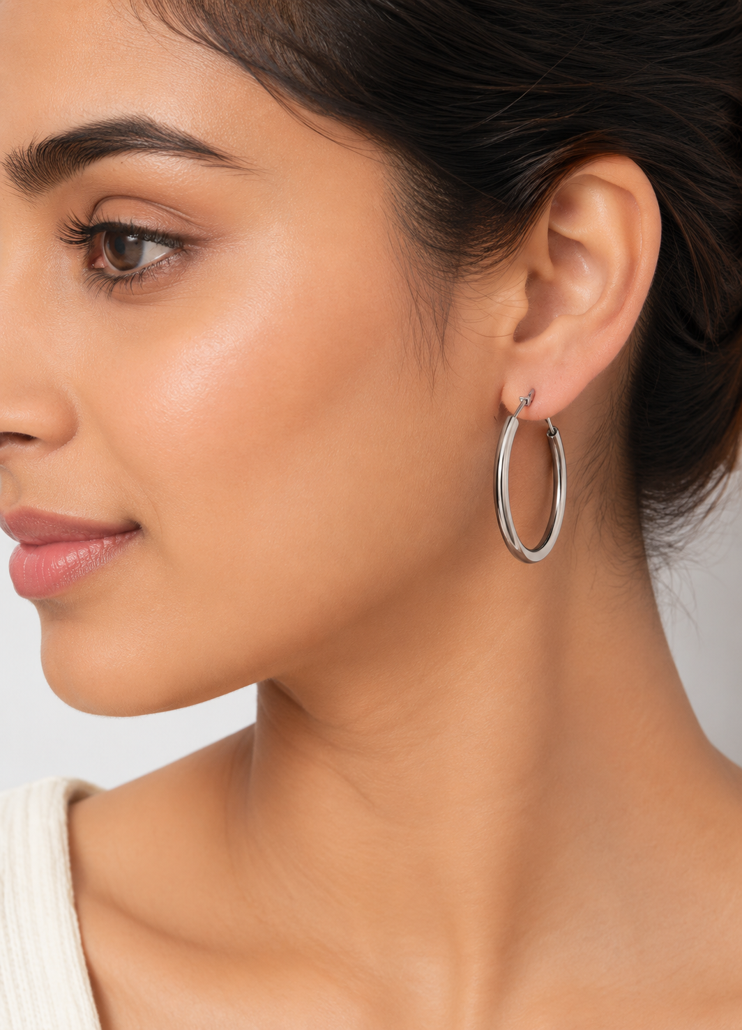 Model wearing Orelva Luna Classic Silver Hoop Earrings with a polished stainless steel finish.