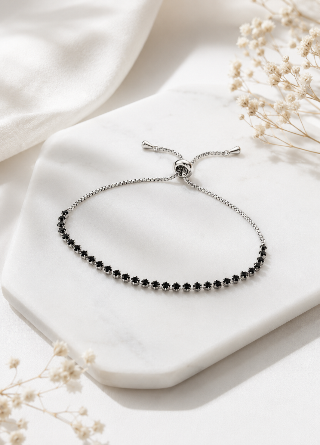 Front view of ORELVA Noir adjustable silver bracelet with black crystal stones.