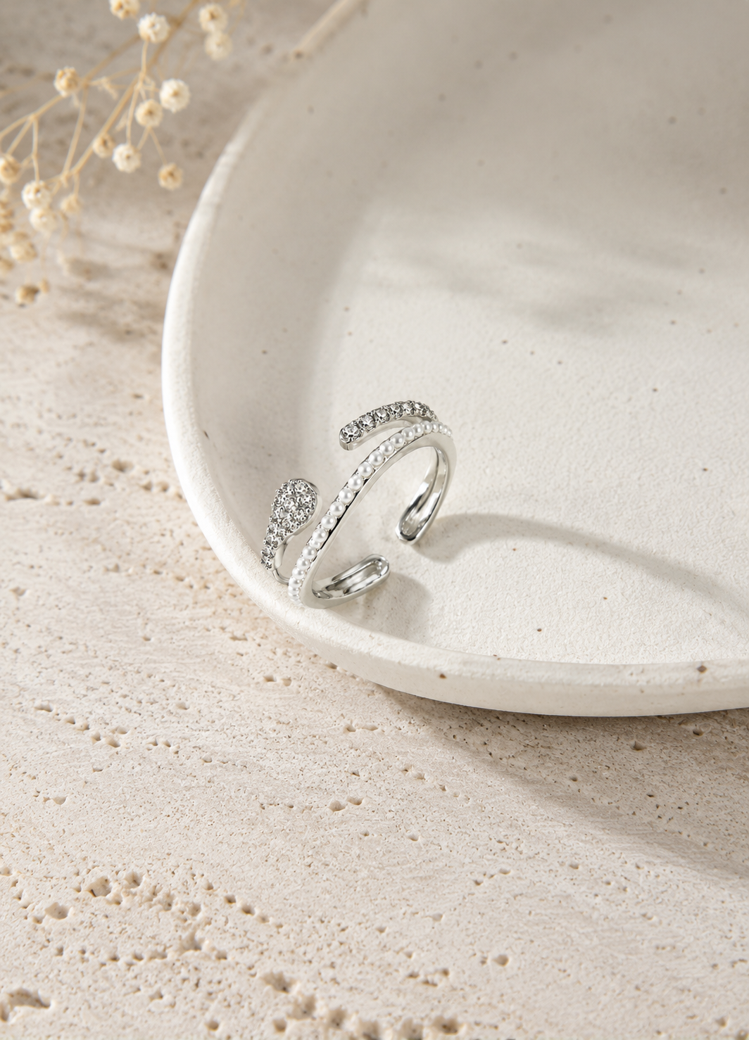 Elegant Orelva silver pearl crystal adjustable ring on ceramic display
