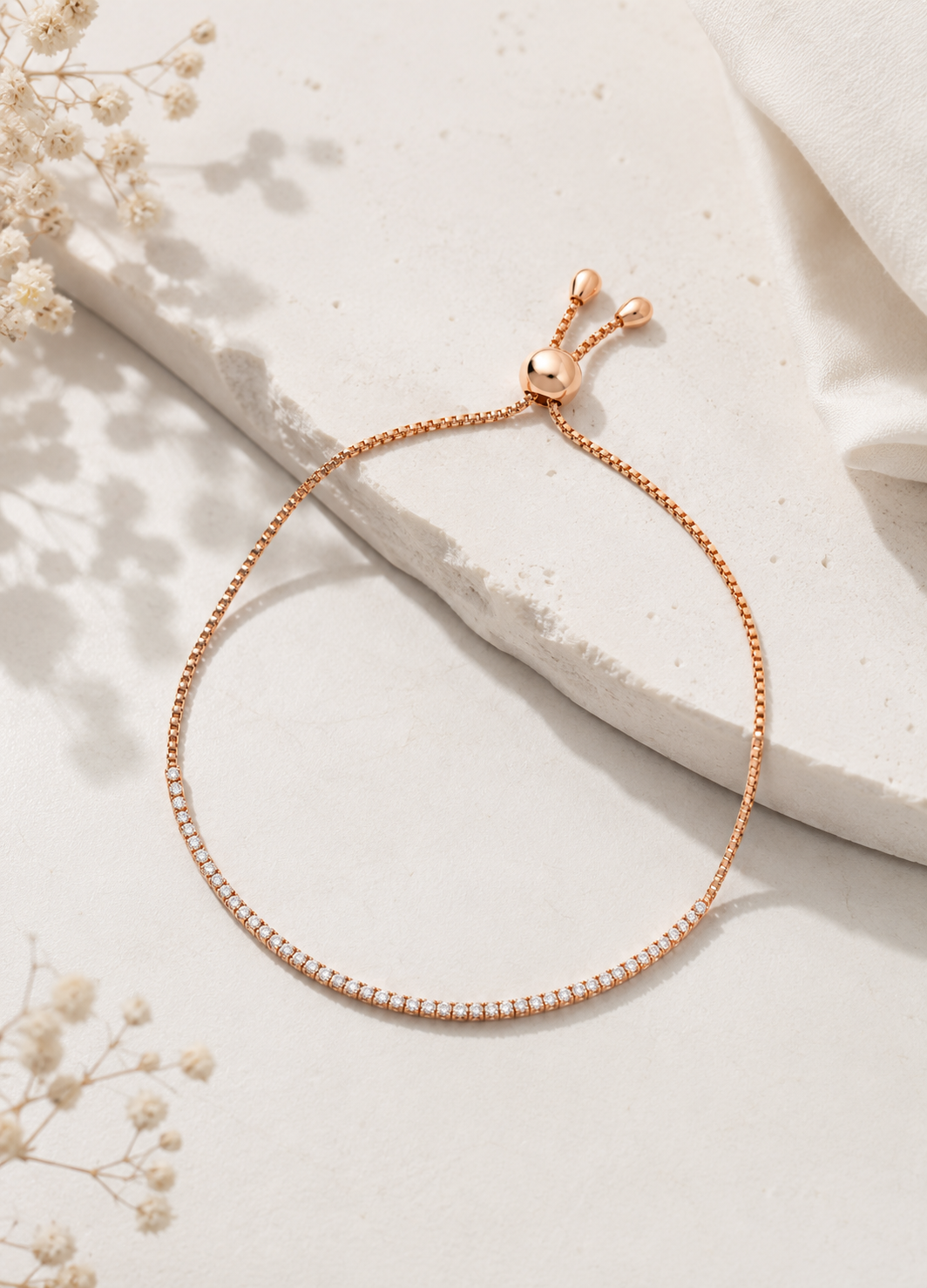 Rose gold adjustable tennis bracelet with sparkling crystal stones by Orelva