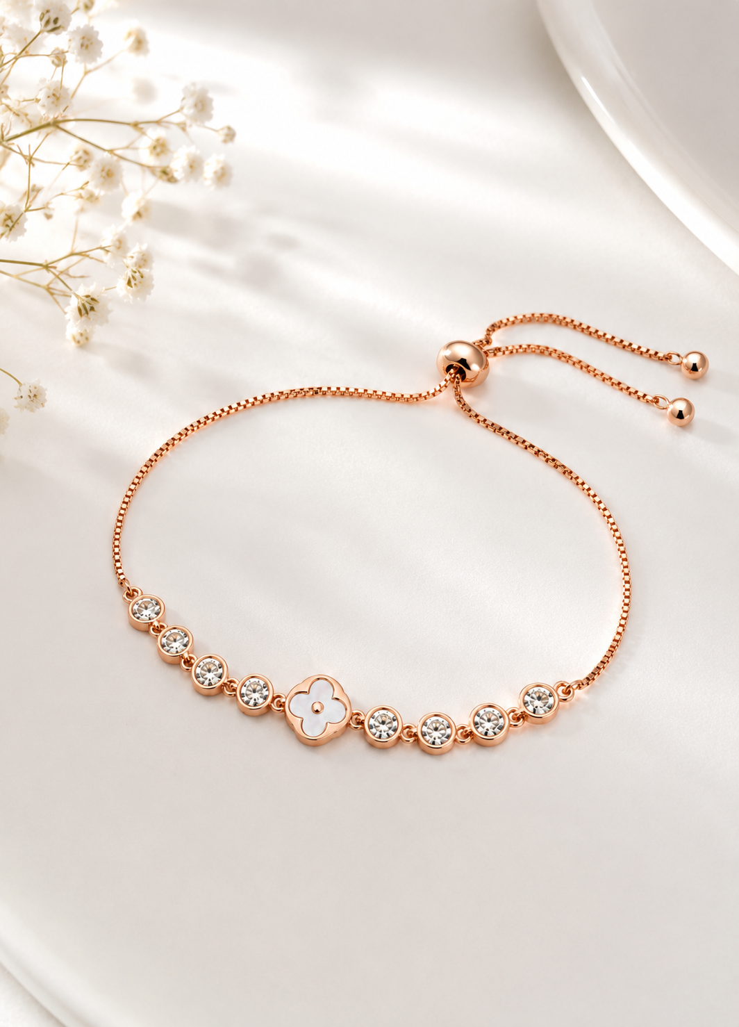 Rose gold bracelet with crystal stones and white clover charm by Orelva