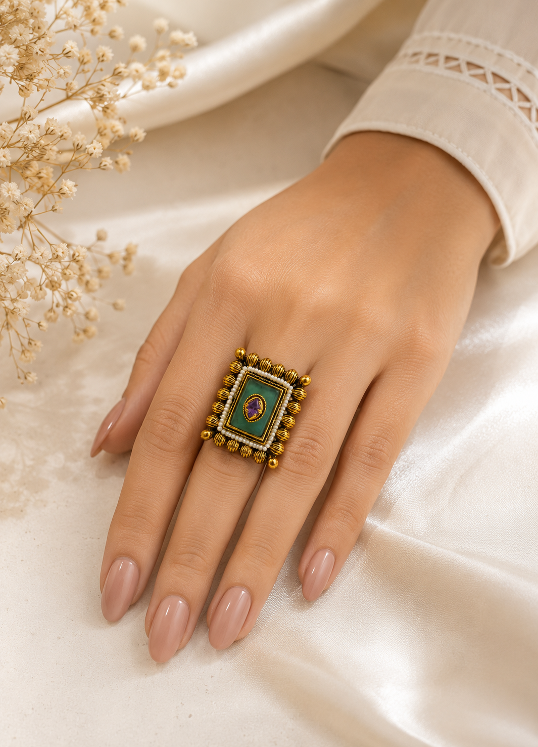 Woman wearing Orelva vintage emerald green pearl statement ring with adjustable gold-tone design.