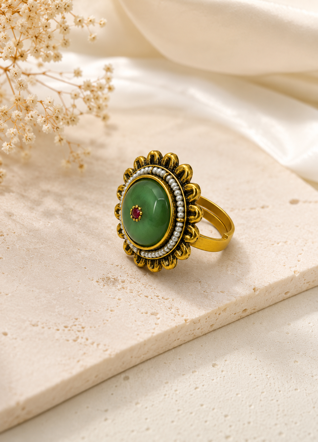 Orelva vintage green pearl statement ring with antique gold finish on a decorative display.